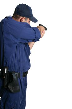 A security officer stands and aims his weapon while on duty or weapons training.