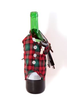 bottle dressed in jacket warmer with keys and alcohol on white background depicting drunk driving and addictions can kill