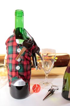 bottle dressed in jacket warmer with keys as arms on white background depicting drunk driving