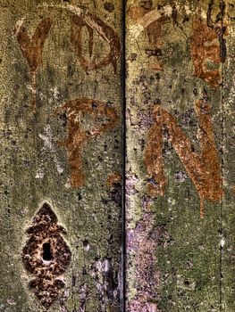 HDR image of scribblings and graffiti on an old door in Mdina