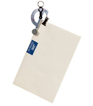 Small balance type scale weighing an envelope with airmail stamp