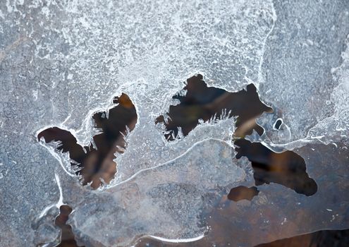 Macro of the ice sheet above a small stream showing intricate shapes