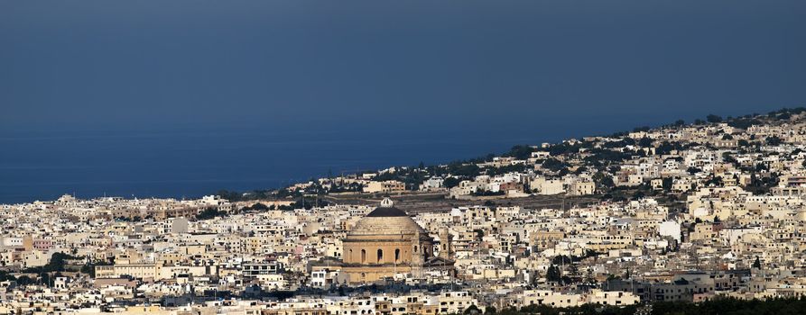 Mosta dome and its surroundings as seen from the bastions of the medieval city of Mdina