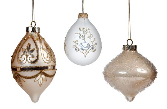 A trio of gold decorated xmas decorations hanging and isolated against white background