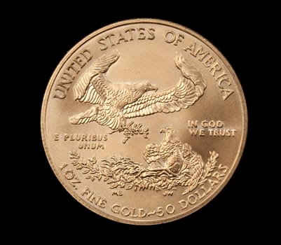 Macro shot of the Eagle side of a pure gold coin