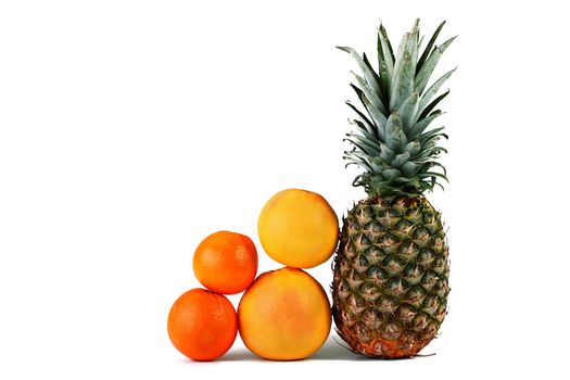 The pineapple, two grapefruits and two oranges on a white background.