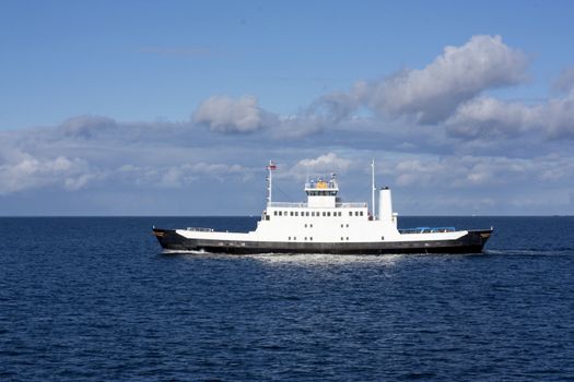 Small ferry boat on the open sea in north west Norway, carrying a bus