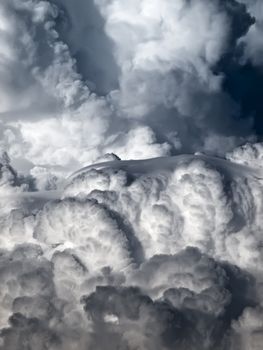 Towering detailed cumulus cloud with lenticular formations
