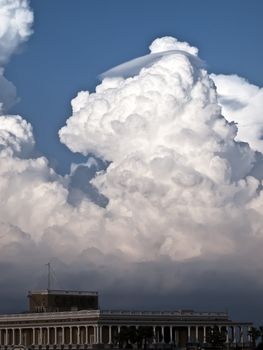 Towering detailed cumulus cloud with lenticular formations over the casino in St Julians in Malta