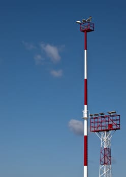 Airfield lighting tower against a clear blue sky