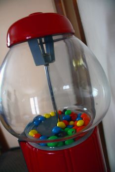 a vintage gumball machine with candy in it