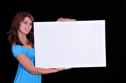 lovely young teen beauty holding a blank sign on black
