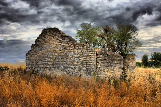 A disused barn under a cloudy sky