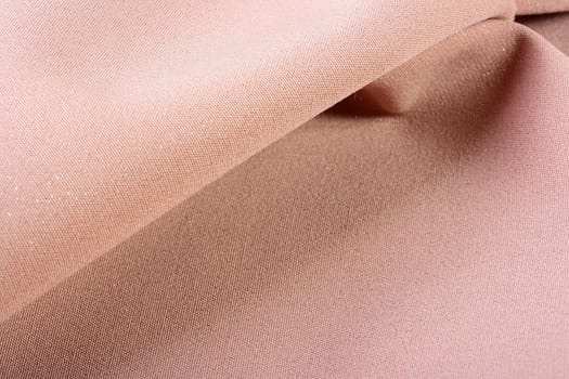Background from a beige fabric which is used in a clothing industry.