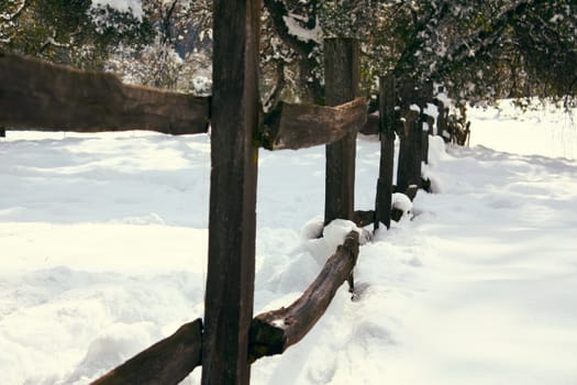 Old wood fence in the snow