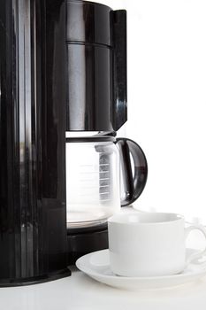 Coffee machine and cup on white