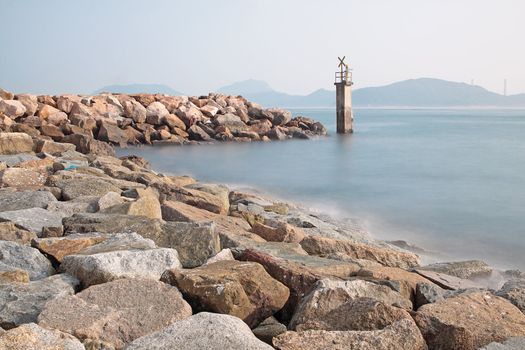Lighthouse on a Rocky Breakwall: A small lighthouse warns of a rough shoreline. 