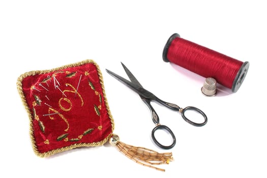 Ancient scissors, thimble and small pillow for needles.