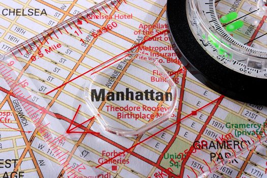 USA map with the city of New York and a compass with magnifying glass over Manhattan.