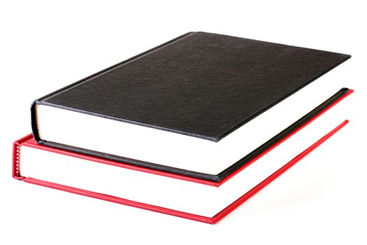 The black closed book lies on red both books on a white background.