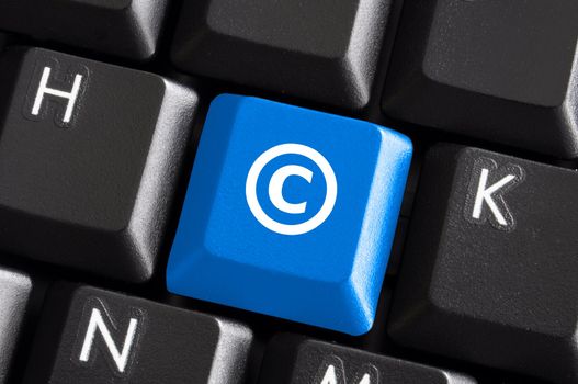 copyright concept with blue button on computer keyboard