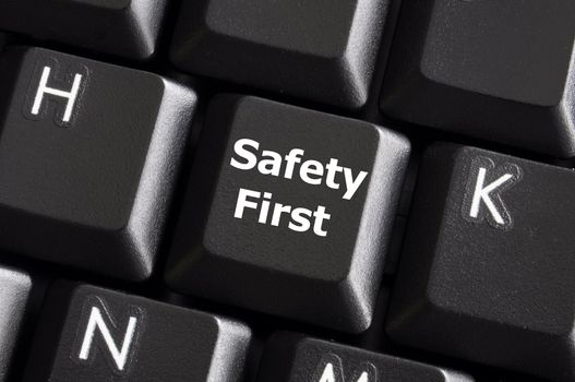 safety first concept with key on computer keyboard