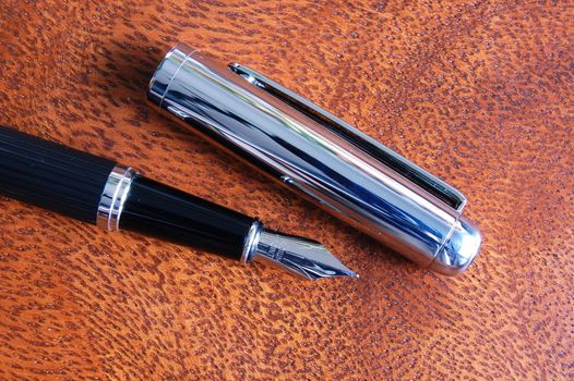 business fountain pen on a wood desktop in an office