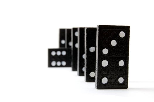 row of dominoes including a special domino stone isolated on white background