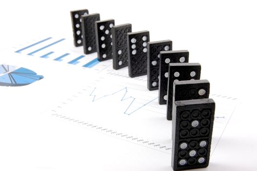 some domino stones on a blue business chart