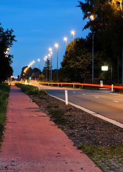 Main road in twilight with car trails