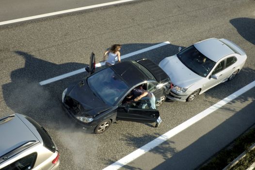 A small shunt on the freeway (motorway, autoroute, autobahn) a few seconds after it happened. Steam can be seen coming from under the bonnet of the black car. Motion blur on the passenger fleeing in panic.