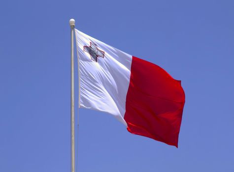The national flag of the island Republic of Malta - proudly displaying the George Cross awarded to Malta in 1942 for Gallantry shown in WWII