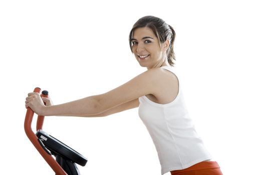 Young woman training on exercise bike at the gym