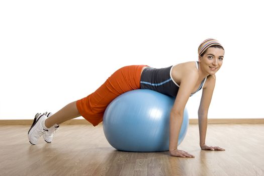 Beautiful young woman making exercises with a core ball