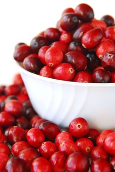 Fresh red cranberries in a bowl on white background