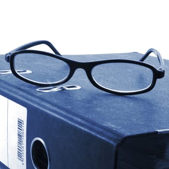 eye glasses and folder in the office showing paperwork concept