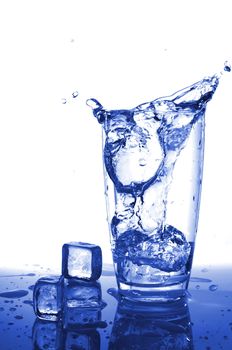 ice water pouring in transparent glass or cup