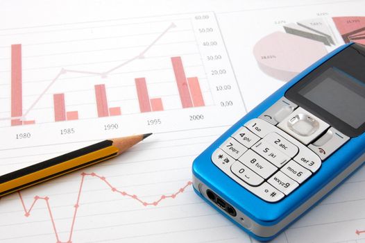 blue cell phone over business chart showing success