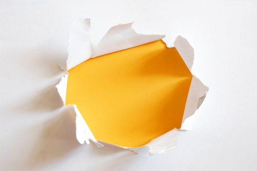 yellow hole in blank sheet paper with copyspace