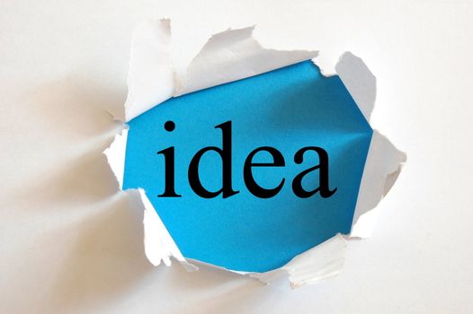 idea on blue background in a paper hole