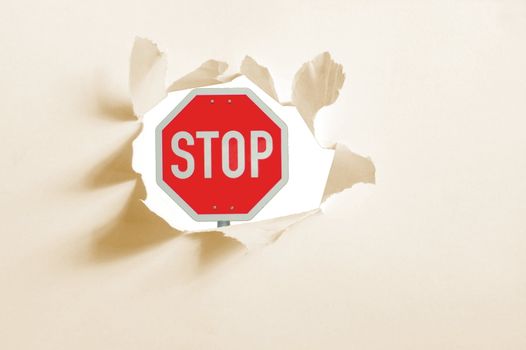 isolated stop sign in a paper hole