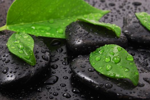 wellness massage or bath concept with zen stones leafes and water drop