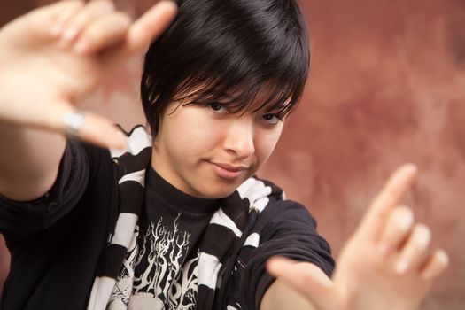 Attractive Ethic Girl Poses for Her Portrait Making a Frame with Hands.