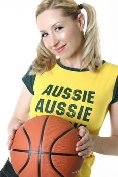 Smiling female holding a basketball.