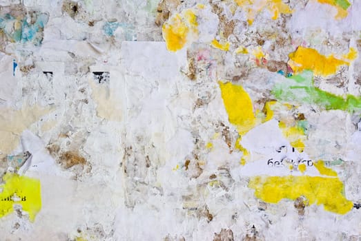 remains of posters and advertisements on old wall