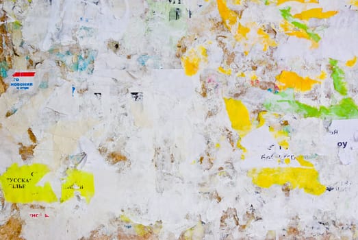 remains of posters and advertisements on old wall