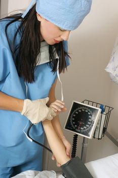 A doctor checking a patient's  blood pressure 
