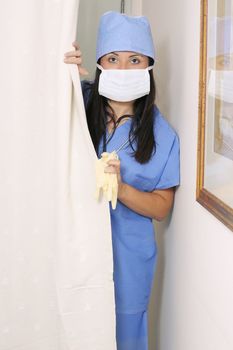 Flu, virus, contamination, disease, sars, epidemic, etc.  Nurse in uniform and protective mask.
