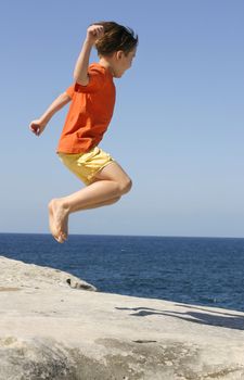 A boy jumping into the air