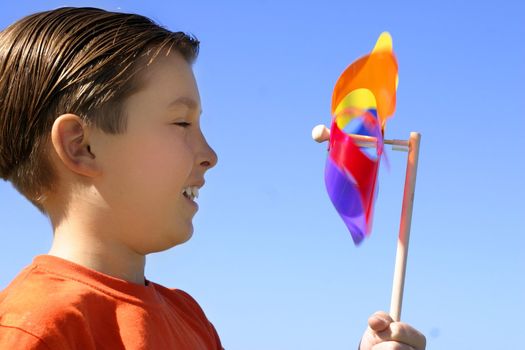 Childs amusement watching a spinning pinwheel toy closeup